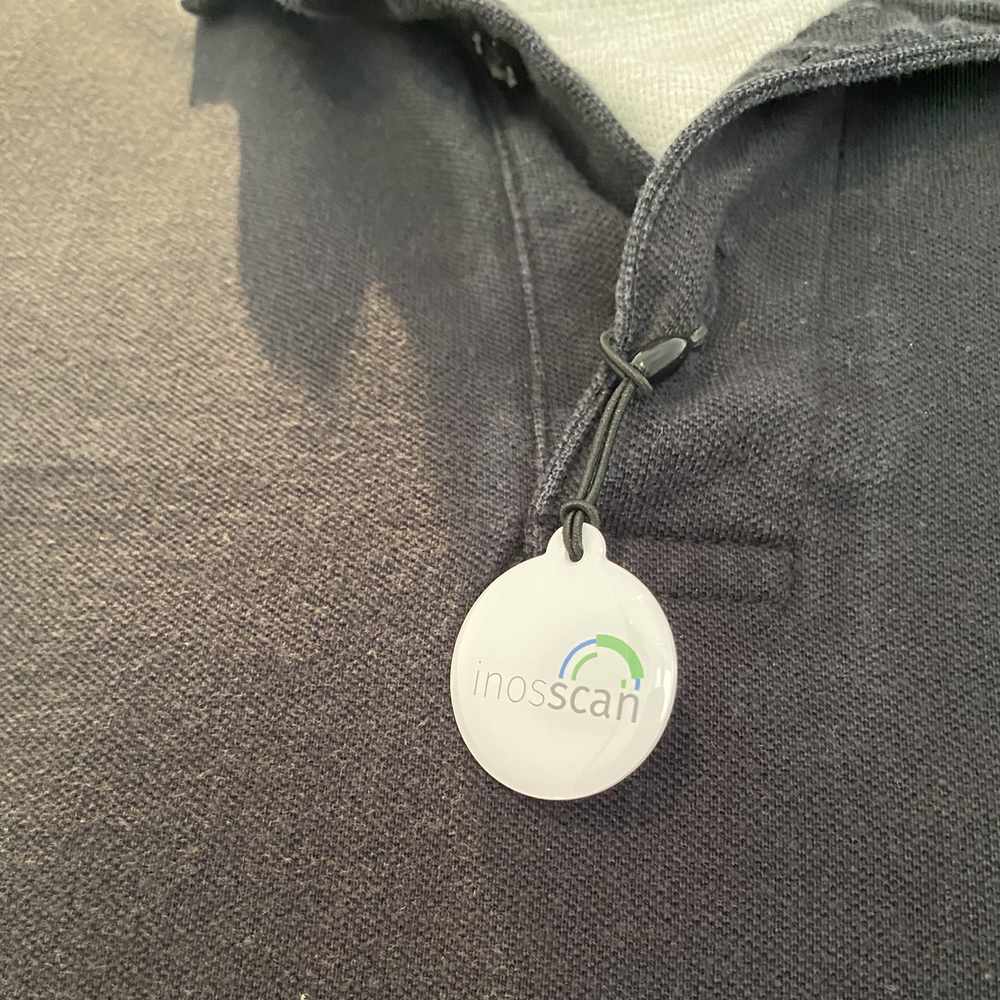 Epoxy NFC tag attached to a shirt button hole